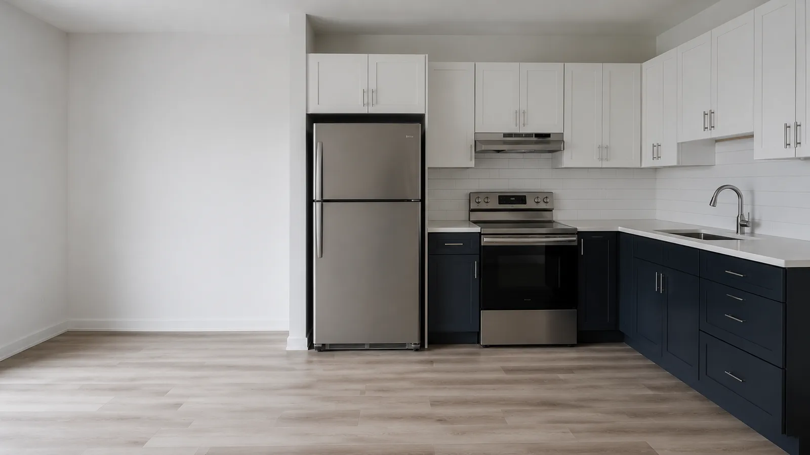 Completed apartment kitchen with white shaker upper cabinets, navy base cabinets and tile backsplash