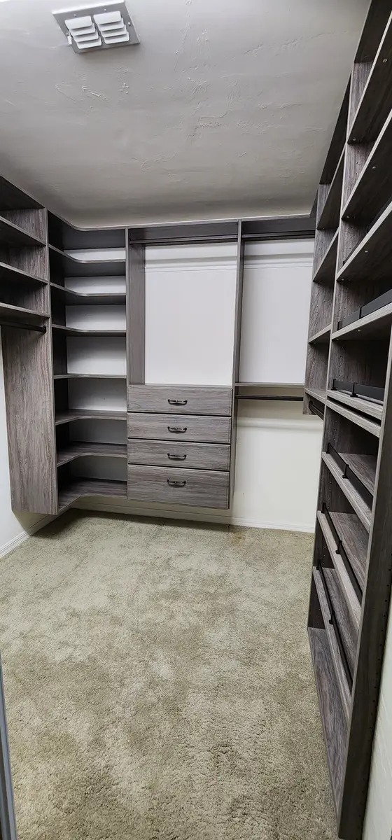 Installed closet system with adjustable shelving and hanging sections