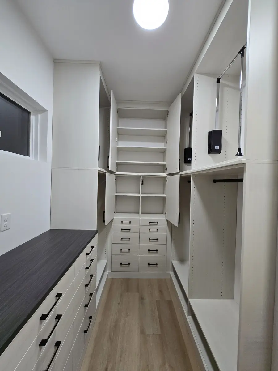 Installed closet system with adjustable shelving and hanging sections