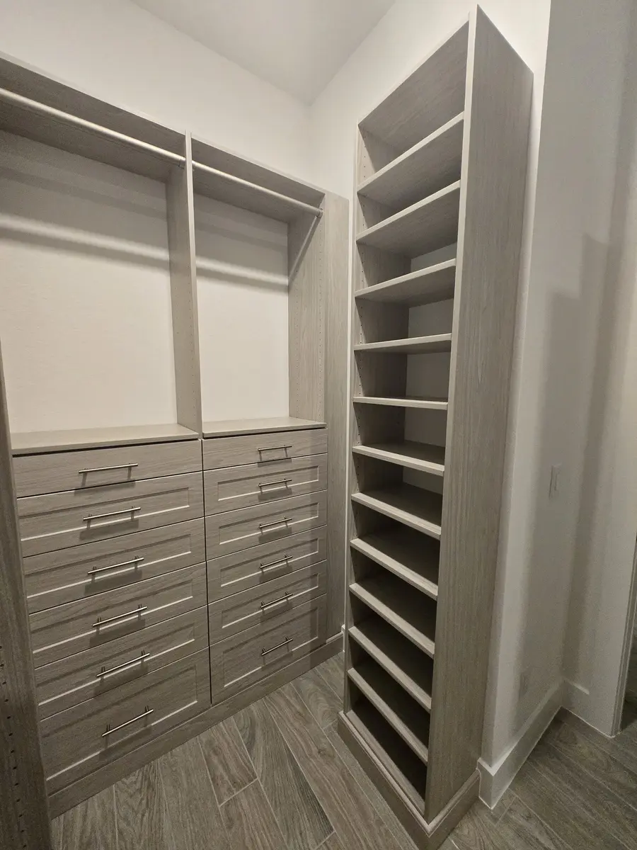 Installed closet system with adjustable shelving and hanging sections