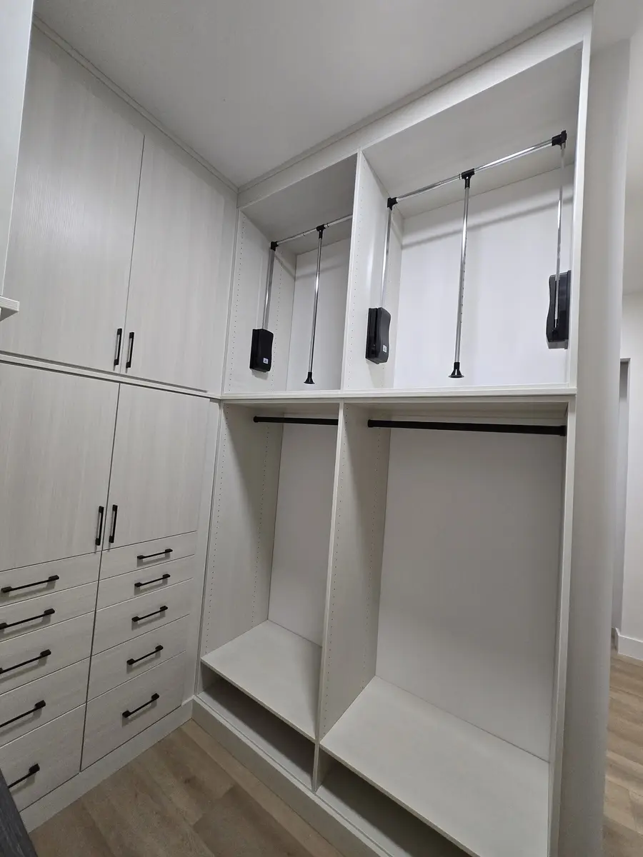 Installed closet system with adjustable shelving and hanging sections