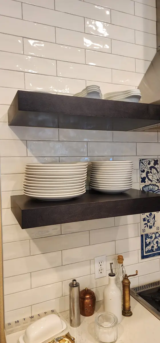 Installed kitchen cabinetry with a tall pantry run and wall oven surround