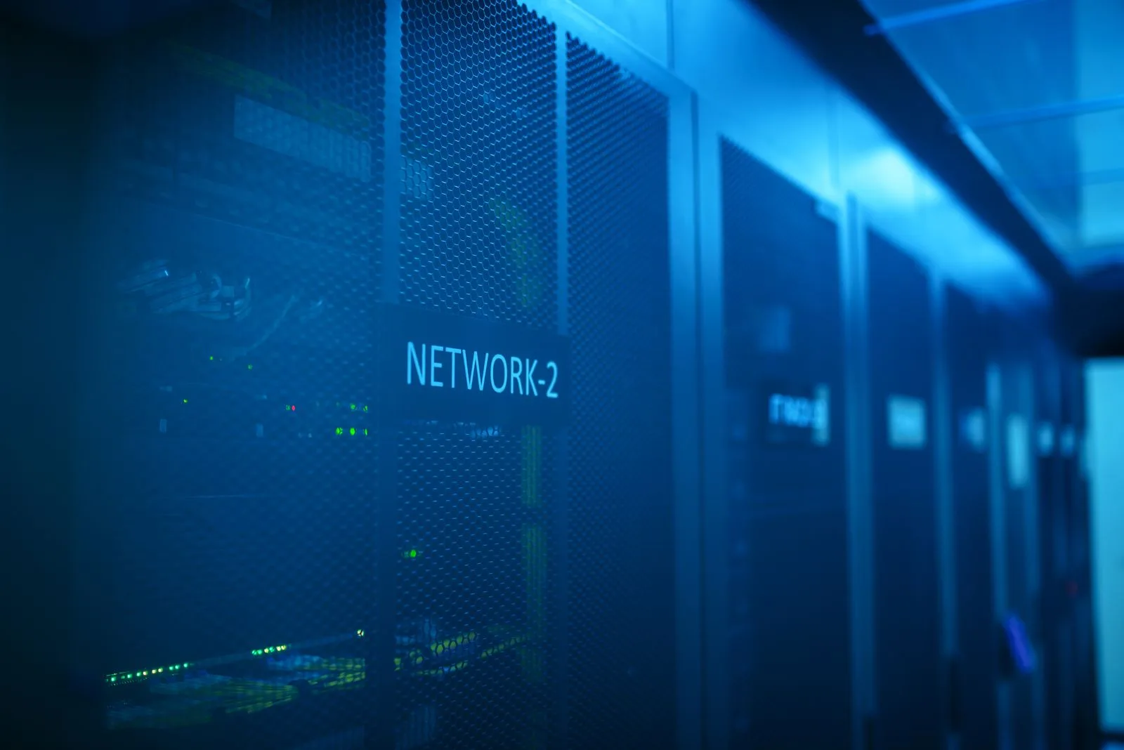 Server rack aisle with illuminated equipment labels
