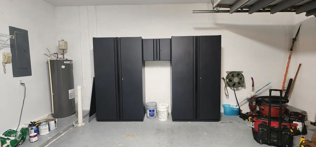 Installed storage cabinetry with full-height doors and shelving