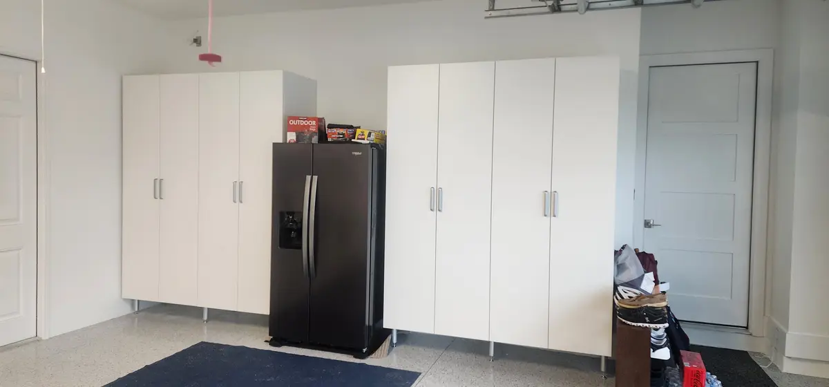 Installed storage cabinetry with full-height doors and shelving