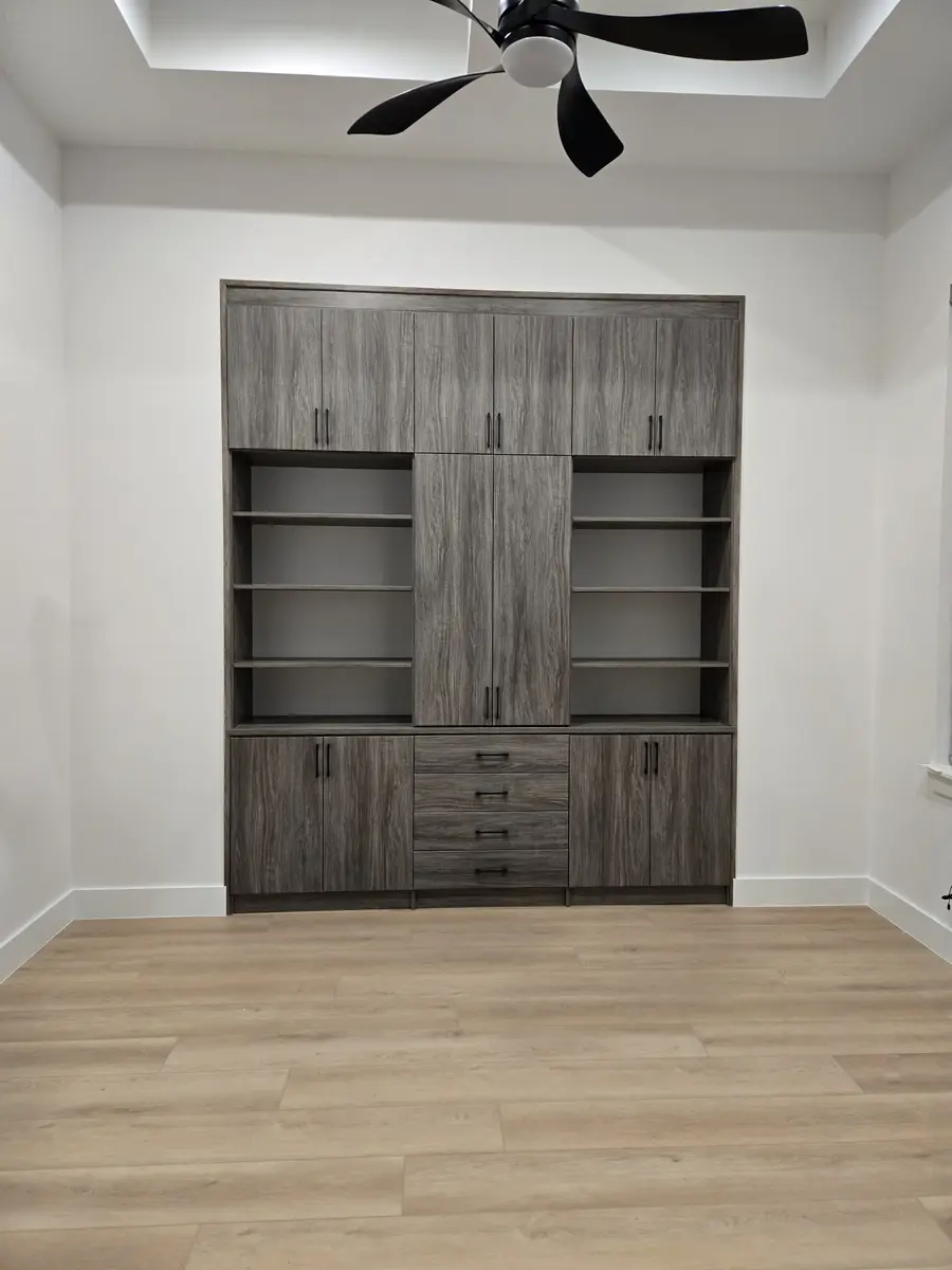 Installed millwork with shelving behind full-height doors