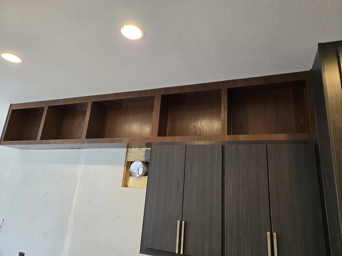Installed built-in cabinetry with a finished top and finished edges