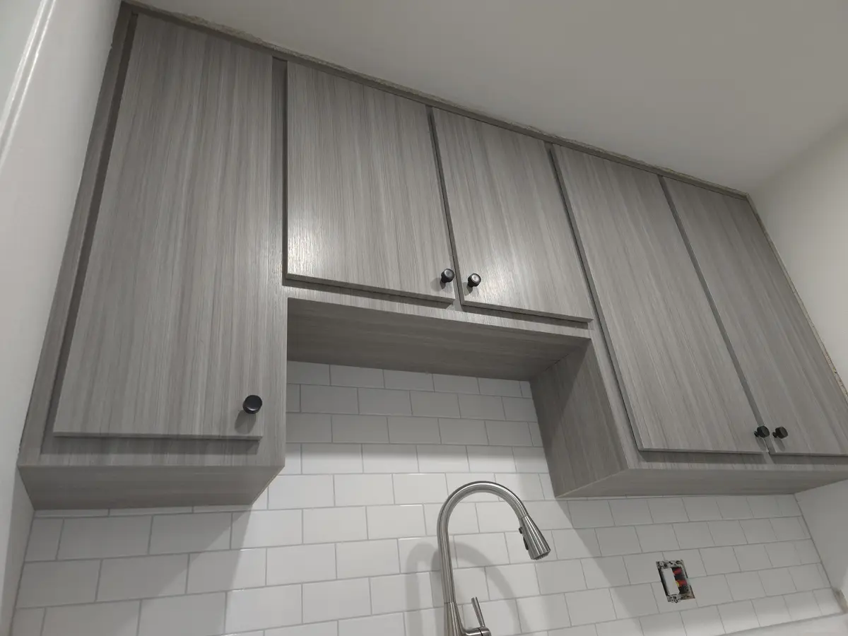Installed millwork with shelving behind full-height doors